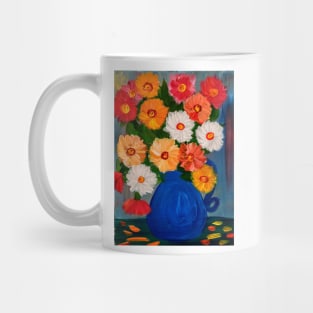 A beautiful bouquet of mixed flowers in a blue vase Mug